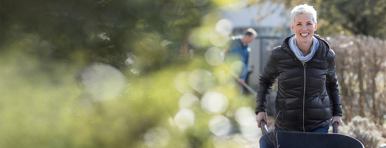 Image of smiling woman working inside the park.